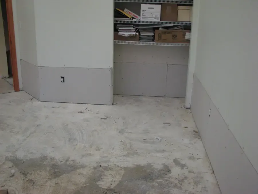 Room with the lower drywall cut away so the wall cavities can dry out