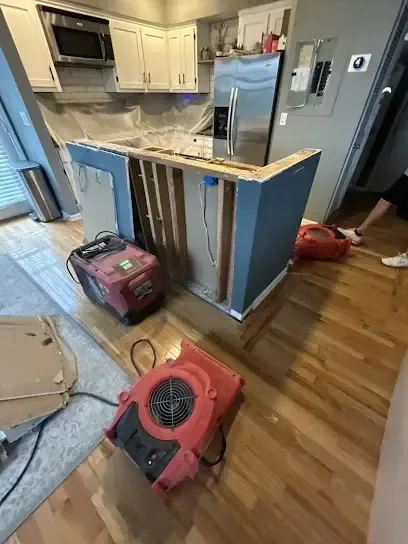 Drying equipment arranged around a kitchen island after a leak