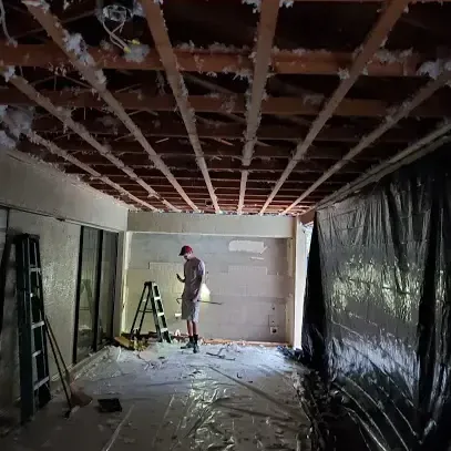 Ceiling opened to the joists behind plastic containment during drying
