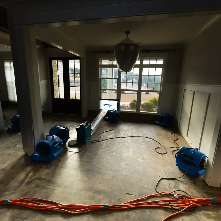 Air movers finishing a structural dry-out in a room of a home